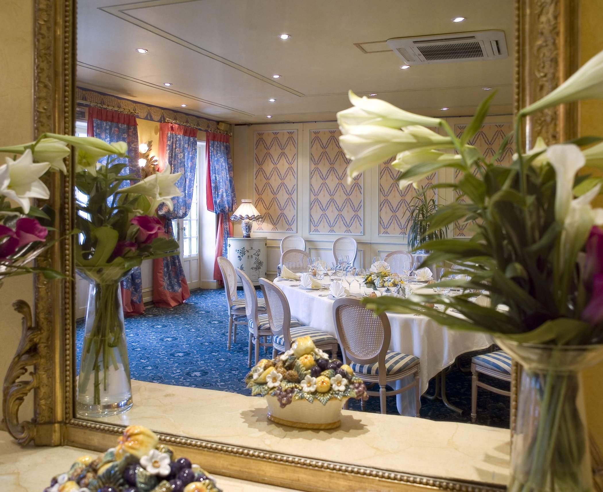 Reflection of the Château de Beaulieu dining room in a mirror